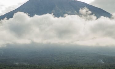 green mountain under white clouds during daytime