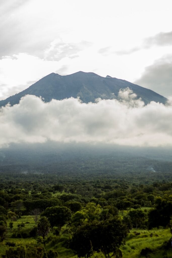 green mountain under white clouds during daytime